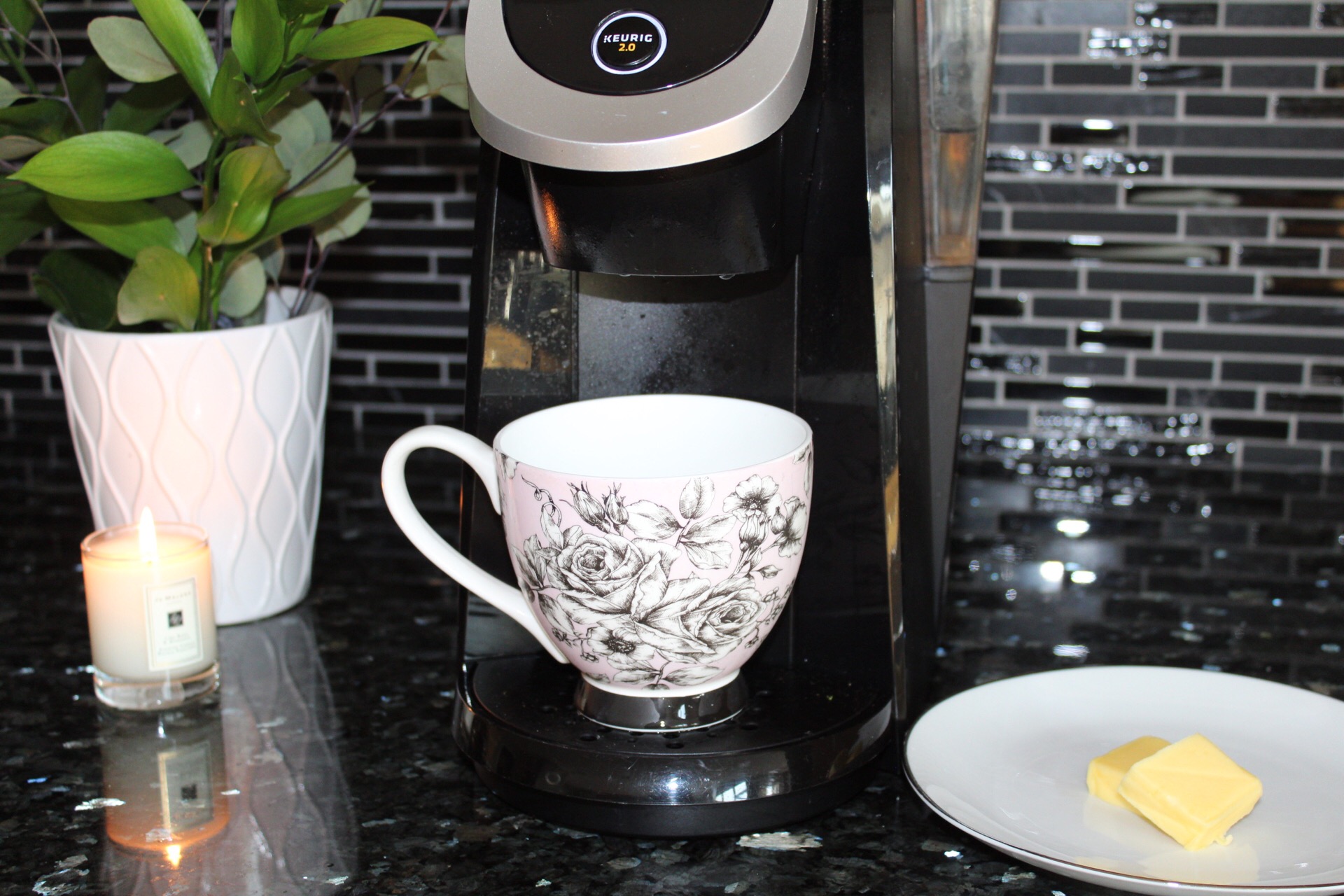 coffee machine with cup. butter on a plate